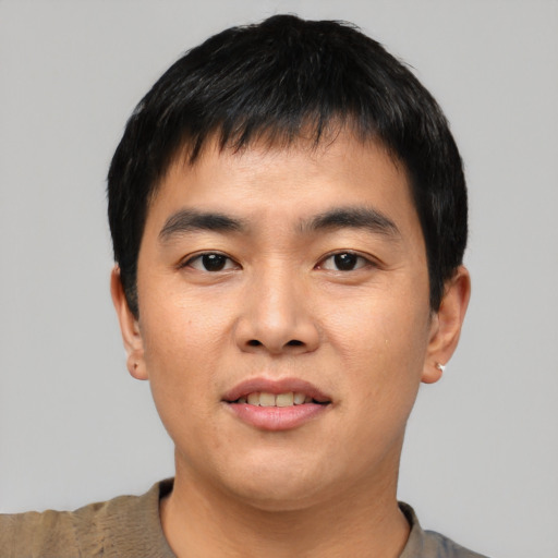 Joyful asian young-adult male with short  black hair and brown eyes