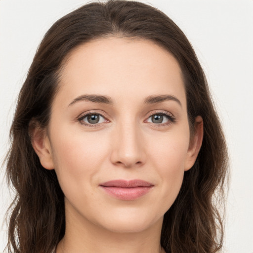 Joyful white young-adult female with long  brown hair and grey eyes