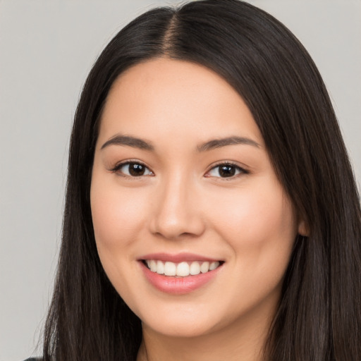 Joyful white young-adult female with long  black hair and brown eyes