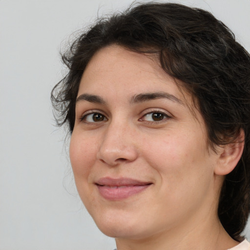 Joyful white adult female with medium  brown hair and brown eyes