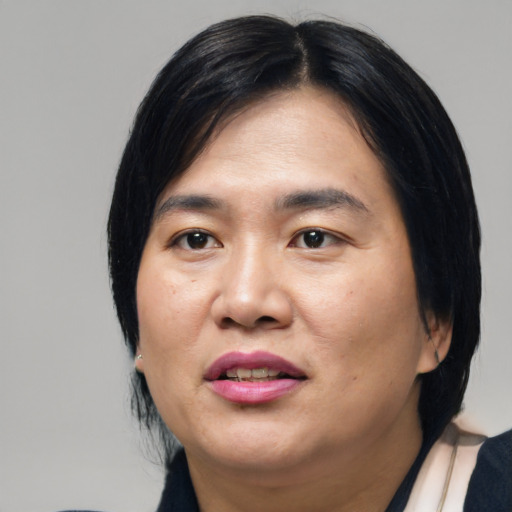 Joyful asian adult female with medium  black hair and brown eyes