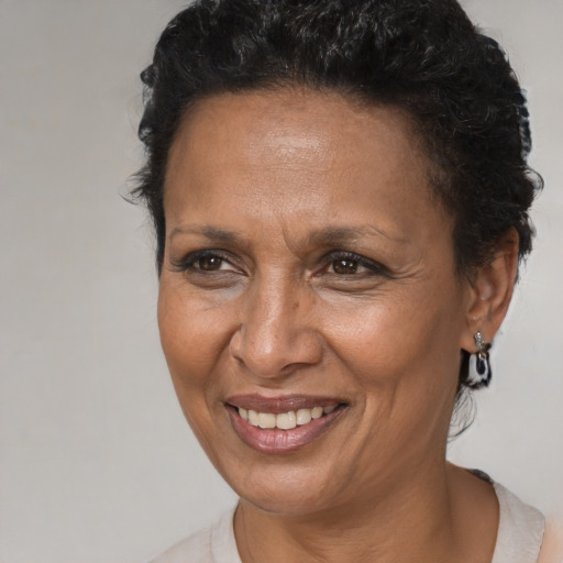 Joyful black adult female with short  brown hair and brown eyes