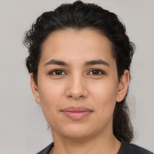 Joyful latino young-adult female with medium  brown hair and brown eyes