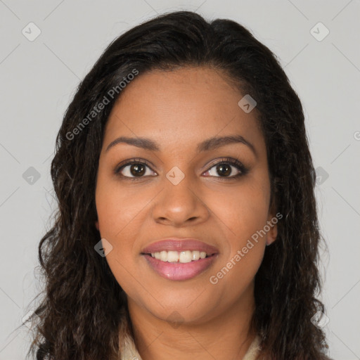 Joyful black young-adult female with long  brown hair and brown eyes