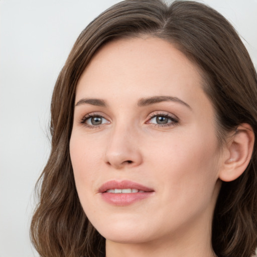 Joyful white young-adult female with long  brown hair and green eyes