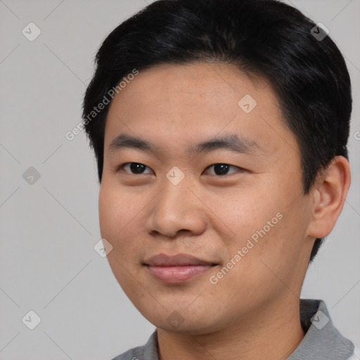 Joyful asian young-adult male with short  black hair and brown eyes