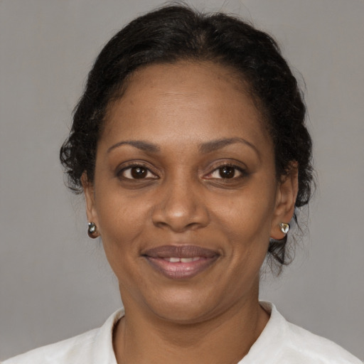 Joyful black adult female with short  brown hair and brown eyes
