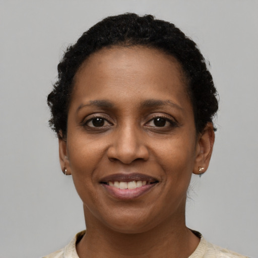 Joyful black young-adult female with short  brown hair and brown eyes