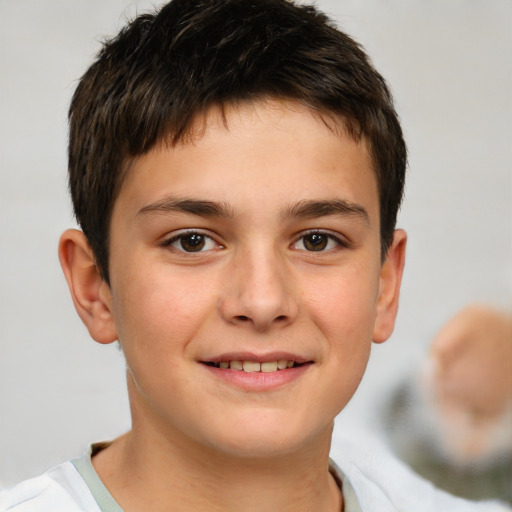 Joyful white child male with short  brown hair and brown eyes