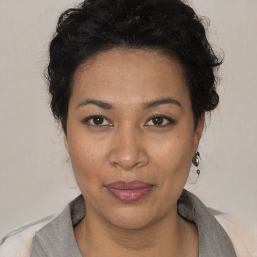 Joyful black adult female with short  brown hair and brown eyes
