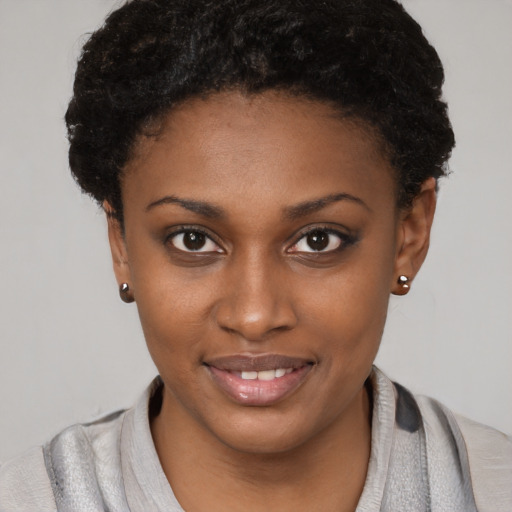 Joyful black young-adult female with short  brown hair and brown eyes