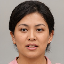 Joyful asian young-adult female with medium  brown hair and brown eyes