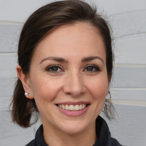 Joyful white adult female with medium  brown hair and brown eyes