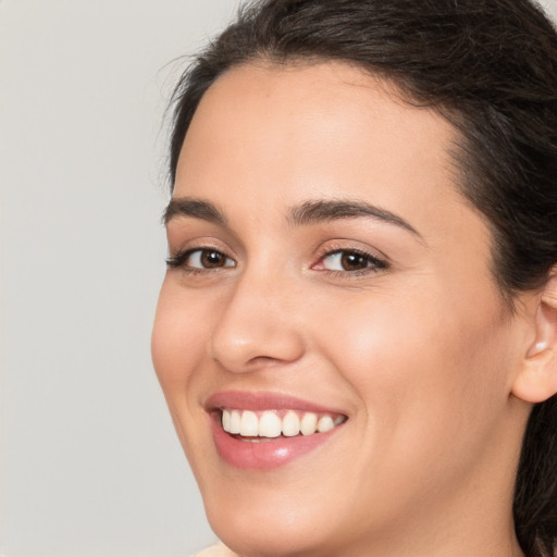 Joyful white young-adult female with long  brown hair and brown eyes