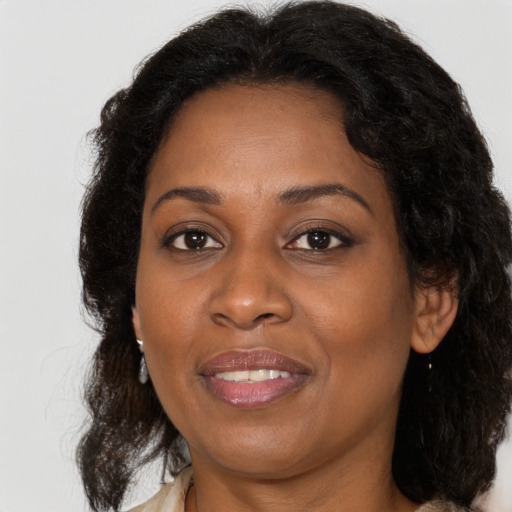 Joyful black adult female with medium  brown hair and brown eyes