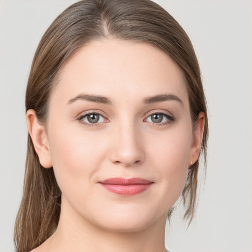 Joyful white young-adult female with medium  brown hair and grey eyes