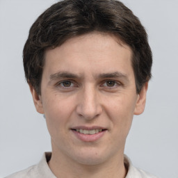 Joyful white adult male with short  brown hair and brown eyes