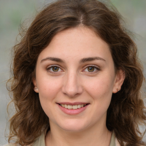 Joyful white young-adult female with medium  brown hair and green eyes