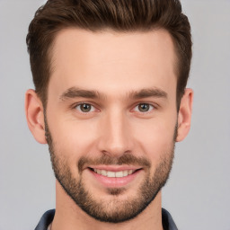 Joyful white young-adult male with short  brown hair and brown eyes