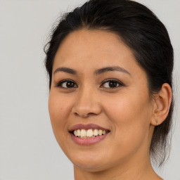 Joyful latino young-adult female with medium  brown hair and brown eyes