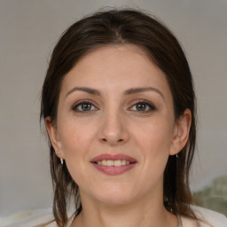 Joyful white young-adult female with medium  brown hair and brown eyes