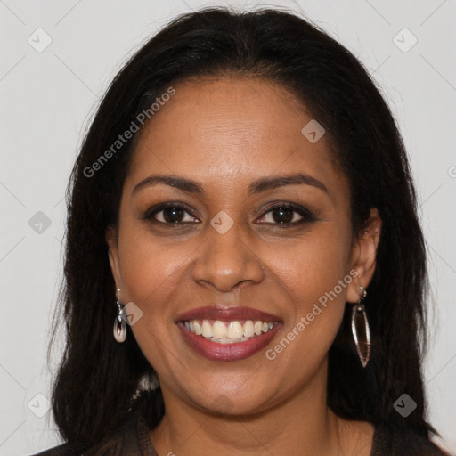 Joyful black young-adult female with long  brown hair and brown eyes