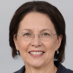 Joyful white adult female with medium  brown hair and grey eyes