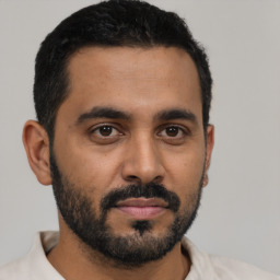 Neutral latino young-adult male with short  black hair and brown eyes