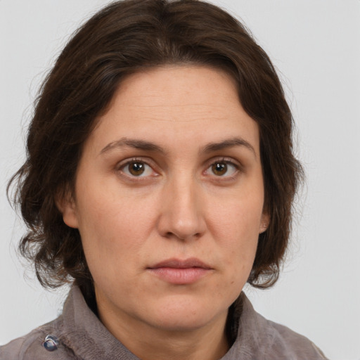 Joyful white adult female with medium  brown hair and grey eyes