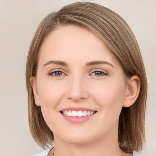 Joyful white young-adult female with medium  brown hair and green eyes