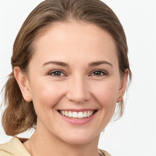 Joyful white young-adult female with medium  brown hair and grey eyes