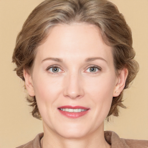 Joyful white adult female with medium  brown hair and grey eyes