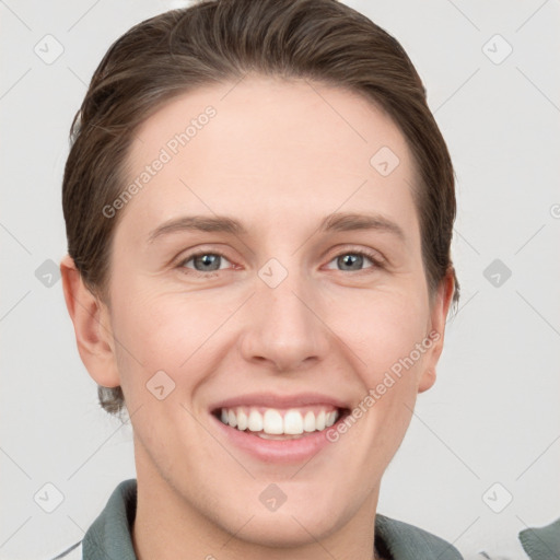 Joyful white young-adult female with short  brown hair and grey eyes