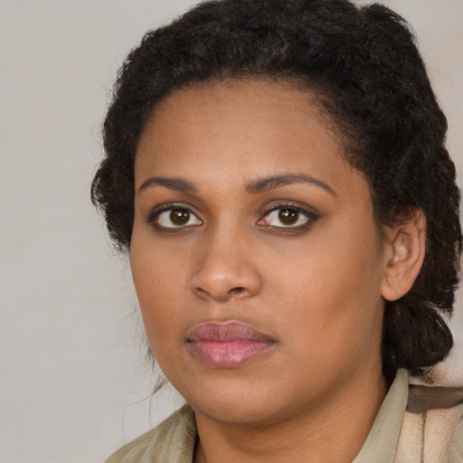 Neutral black young-adult female with medium  brown hair and brown eyes