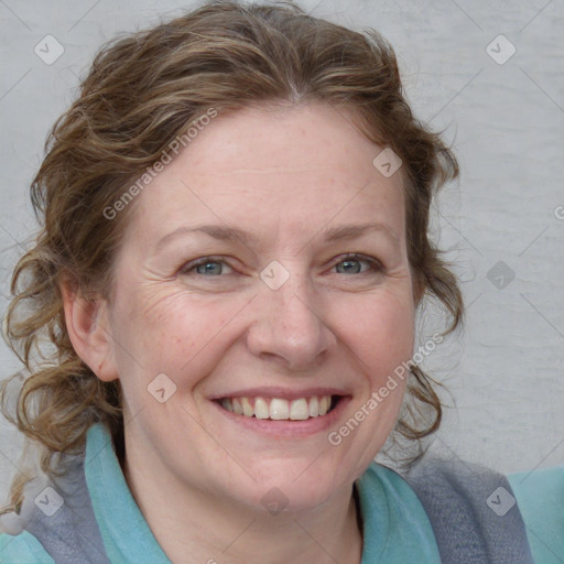 Joyful white adult female with medium  brown hair and blue eyes