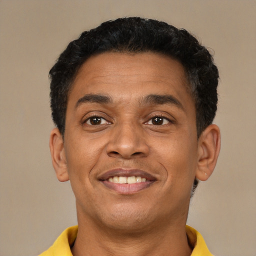 Joyful latino young-adult male with short  brown hair and brown eyes