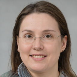 Joyful white adult female with medium  brown hair and grey eyes