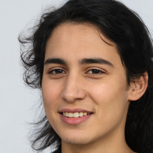 Joyful white young-adult female with long  brown hair and brown eyes