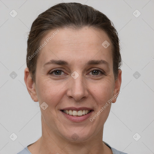 Joyful white adult female with short  brown hair and grey eyes