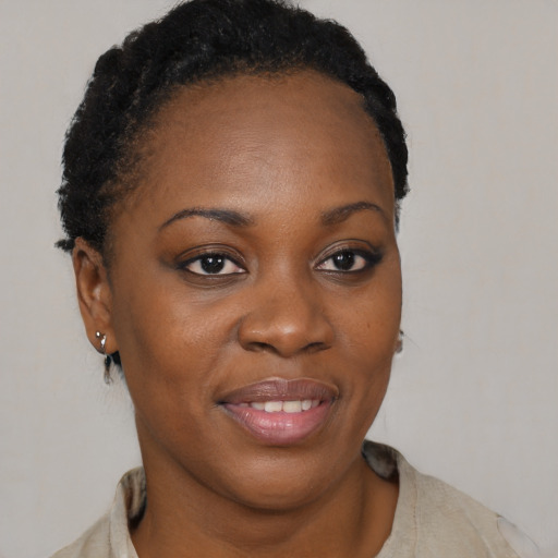 Joyful black young-adult female with short  brown hair and brown eyes