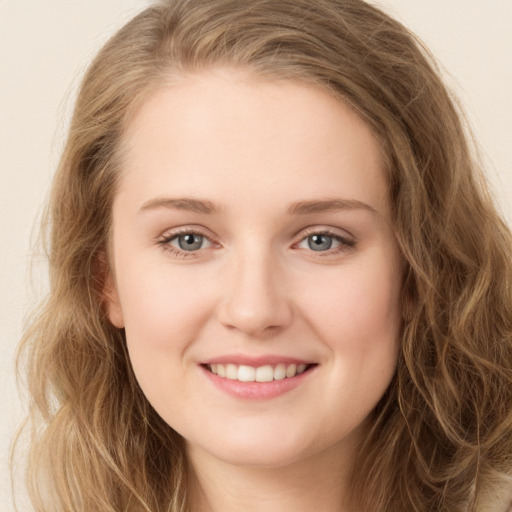 Joyful white young-adult female with long  brown hair and green eyes