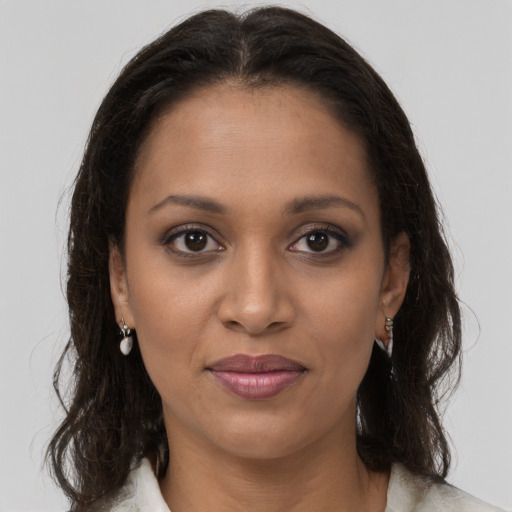 Joyful black young-adult female with medium  brown hair and brown eyes