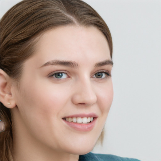 Joyful white young-adult female with long  brown hair and blue eyes