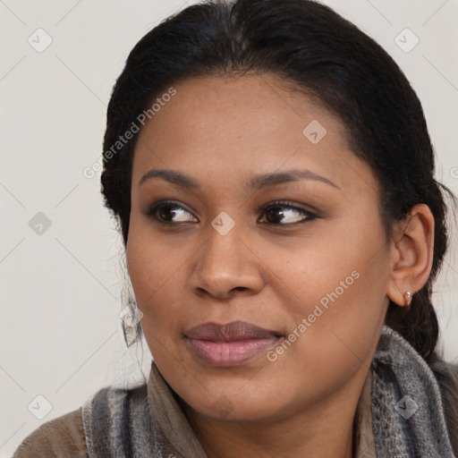 Joyful black young-adult female with medium  brown hair and brown eyes