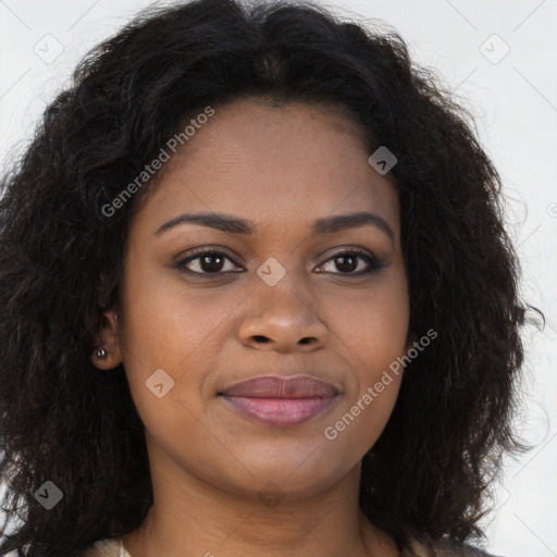 Joyful black young-adult female with long  brown hair and brown eyes