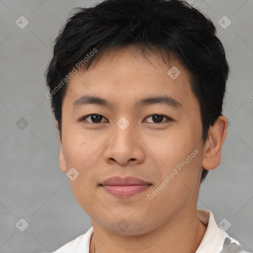 Joyful asian young-adult male with short  brown hair and brown eyes