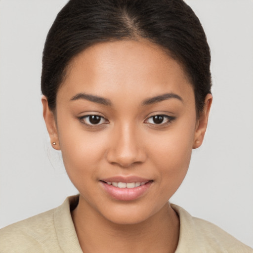 Joyful latino young-adult female with short  brown hair and brown eyes