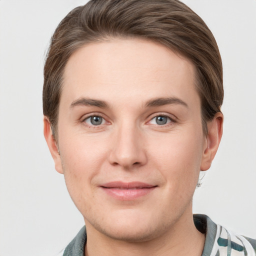 Joyful white young-adult female with short  brown hair and grey eyes