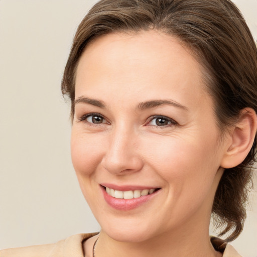 Joyful white young-adult female with medium  brown hair and brown eyes