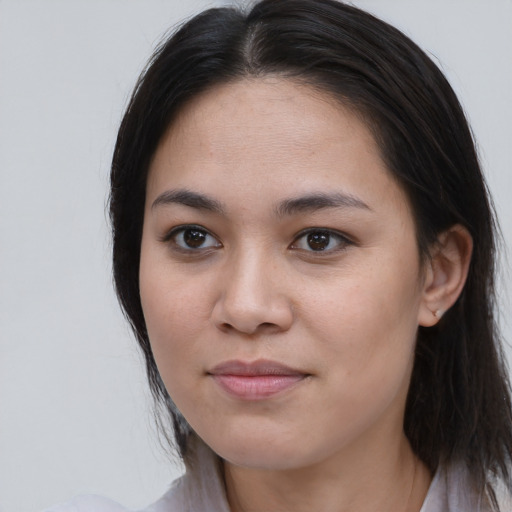 Joyful asian young-adult female with long  brown hair and brown eyes